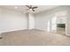 Large carpeted bedroom featuring a ceiling fan and doorway to the en-suite bathroom at 21127 E 62Nd Dr, Aurora, CO 80019