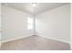 Neutral bedroom featuring soft carpet and a large window for plenty of natural light at 21127 E 62Nd Dr, Aurora, CO 80019