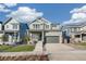 Inviting two-story home featuring a covered porch, a two-car garage, and a well-maintained lawn at 21127 E 62Nd Dr, Aurora, CO 80019