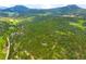Expansive mountain views surround this home, nestled among trees and nature at 9633 Fox Valley Dr, Morrison, CO 80465
