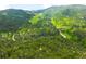 A home nestled among lush green trees and hillside in a serene and natural setting at 9633 Fox Valley Dr, Morrison, CO 80465