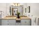 Bathroom features a double vanity, ample lighting, and stylish decor for a spa-like experience at 9633 Fox Valley Dr, Morrison, CO 80465