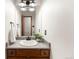 Cozy bathroom with well-lit vanity, wooden cabinets, and neutral decor for a clean aesthetic at 9633 Fox Valley Dr, Morrison, CO 80465