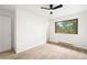 Bright carpeted bedroom with ceiling fan, window, and white trim at 9633 Fox Valley Dr, Morrison, CO 80465