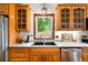 A kitchen features wood cabinets, countertops, stainless steel appliances, and a window view at 9633 Fox Valley Dr, Morrison, CO 80465