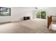 Living room features ample natural light, neutral carpeting, and a sliding glass door to the deck at 9633 Fox Valley Dr, Morrison, CO 80465