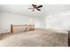 Upstairs living room features neutral carpet, railing, and a ceiling fan for added comfort at 9633 Fox Valley Dr, Morrison, CO 80465