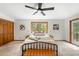 Bright bedroom boasts scenic views, a ceiling fan, and plush carpeting for a cozy retreat at 9633 Fox Valley Dr, Morrison, CO 80465