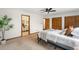 Spacious bedroom with a plant, adjacent bathroom, closet, ceiling fan, and soft carpeting for added comfort at 9633 Fox Valley Dr, Morrison, CO 80465