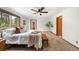 Comfortable bedroom features a ceiling fan, neutral carpeting, and a large picture window with a beautiful view at 9633 Fox Valley Dr, Morrison, CO 80465