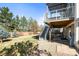 Spacious backyard featuring a deck with stairs, green lawn, and mature trees at 10055 Hughes Pl, Highlands Ranch, CO 80126