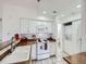 This kitchen features white cabinets, white appliances, and a sink at 13844 E Lehigh Ave # H, Aurora, CO 80014