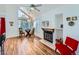 This living room has great natural light, a fireplace, and hardwood floors at 13844 E Lehigh Ave # H, Aurora, CO 80014