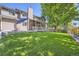 Expansive backyard with lush lawn, mature trees, and inviting patio area perfect for outdoor living at 1607 Garnet St, Broomfield, CO 80020