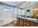 Bathroom features double sinks and a bathtub with shower at 1607 Garnet St, Broomfield, CO 80020