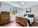 This bedroom is furnished with a wooden bed, dresser and hardwood flooring at 1607 Garnet St, Broomfield, CO 80020