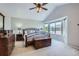 This primary bedroom has a vaulted ceiling, large bay windows, and wood furniture at 1607 Garnet St, Broomfield, CO 80020