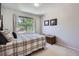Cozy bedroom with a large window and neutral walls at 1607 Garnet St, Broomfield, CO 80020