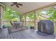 Relaxing covered deck featuring an outdoor dining area and grill, perfect for entertaining at 1607 Garnet St, Broomfield, CO 80020