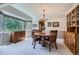 Elegant dining room with a round table, chandelier, and large window at 1607 Garnet St, Broomfield, CO 80020
