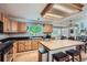 Spacious kitchen with granite countertops, wooden cabinets, and a center island at 1607 Garnet St, Broomfield, CO 80020