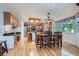 Open floor plan featuring the kitchen and dining area, with hardwood floors and light filled windows at 1607 Garnet St, Broomfield, CO 80020