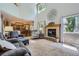 Bright living room has a vaulted ceiling, a fireplace and large windows at 1607 Garnet St, Broomfield, CO 80020