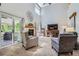 Vaulted living room with large windows, fireplace and sliding glass door to the deck at 1607 Garnet St, Broomfield, CO 80020