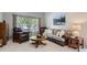 Cozy living room featuring neutral tones, a comfortable sofa, and a large window at 1607 Garnet St, Broomfield, CO 80020