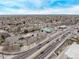 Wide aerial shot capturing a city area with a gas station, shops, and surrounding residential neighborhoods at 677 Vrain St # 10, Denver, CO 80204