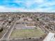 An aerial view displaying a school, a park and neighborhood street at 677 Vrain St # 10, Denver, CO 80204