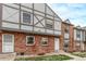 Attractive brick townhouse featuring Tudor-style architectural details and a neatly kept lawn at 677 Vrain St # 10, Denver, CO 80204
