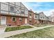 Street view of brick townhouses with Tudor elements and well-maintained landscaping at 677 Vrain St # 10, Denver, CO 80204