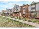 Charming row of townhouses showcasing brick facades, Tudor-inspired designs, and green lawns at 677 Vrain St # 10, Denver, CO 80204