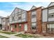 Row of attractive townhouses boasting brick exteriors, Tudor accents, and tidy front yards at 677 Vrain St # 10, Denver, CO 80204
