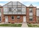 Charming brick townhouse featuring Tudor-style accents and a well-manicured front lawn at 677 Vrain St # 10, Denver, CO 80204