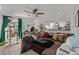 Inviting living room area with a spacious couch, ceiling fan, and adjacent kitchen view at 677 Vrain St # 10, Denver, CO 80204