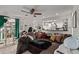 Comfortable living room with plush sofa, ceiling fan, and open view to the kitchen at 677 Vrain St # 10, Denver, CO 80204