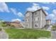 Back exterior with green lawn, professional landscaping, and multi-story home at 1282 Eldorado Dr, Superior, CO 80027