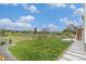 Manicured backyard boasts lush green lawn, gravel beds, a paved path, and privacy fence at 1282 Eldorado Dr, Superior, CO 80027