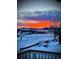 Beautiful backyard view with an orange sunset in the background and snow on the ground at 1282 Eldorado Dr, Superior, CO 80027