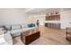 Finished basement boasts a wet bar, wood floors, and ample seating for entertaining at 1282 Eldorado Dr, Superior, CO 80027