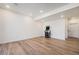Spacious room in the basement has wood floors, recessed lighting, and a retro arcade game at 1282 Eldorado Dr, Superior, CO 80027