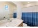 Bright bathroom featuring a single sink vanity and a blue and white shower curtain at 1282 Eldorado Dr, Superior, CO 80027