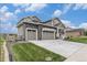 Charming exterior features a stone facade, two-car garage, and well-maintained lawn at 1282 Eldorado Dr, Superior, CO 80027