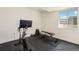 Bright home gym features an exercise bike, weight bench, dumbbells, and a window with a view at 1282 Eldorado Dr, Superior, CO 80027