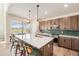 Stylish kitchen features a center island with seating, stainless steel appliances, and sliding doors leading to the outdoor space at 1282 Eldorado Dr, Superior, CO 80027