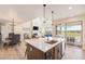 Open-concept kitchen with a large island, stainless steel sink, and seamless flow to the living and dining areas at 1282 Eldorado Dr, Superior, CO 80027