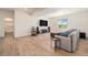 Living room with wood floors, a large TV, speakers, and a grey sofa with blue pillows at 1282 Eldorado Dr, Superior, CO 80027