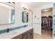 Elegant bathroom featuring double sinks, stylish mirrors, and a walk-in closet for added convenience at 1282 Eldorado Dr, Superior, CO 80027